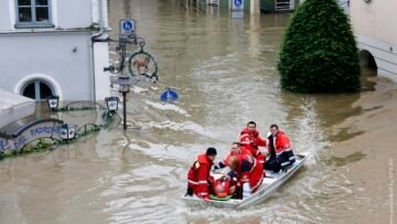 A rescue team on a dinghy evacuates a man from the flooded district of the Bavarian town of Passau